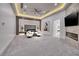 Spacious bedroom with a tray ceiling, fireplace, and sitting area at 665 Overlook Rim Dr, Henderson, NV 89012