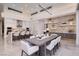 Elegant dining area with long wooden table and white chairs at 665 Overlook Rim Dr, Henderson, NV 89012