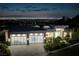 Contemporary home with three-car garage and city views at night at 665 Overlook Rim Dr, Henderson, NV 89012