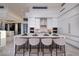 Modern kitchen with white cabinets, island, and breakfast bar at 665 Overlook Rim Dr, Henderson, NV 89012