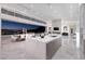 Modern kitchen featuring an island, bar seating, marble floors, and sliding glass doors with a city view at 665 Overlook Rim Dr, Henderson, NV 89012