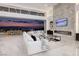 Bright living room with fireplace, sliding glass doors, and amazing city views at 665 Overlook Rim Dr, Henderson, NV 89012