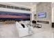 Elegant living room with a white sectional sofa, modern coffee tables, and a fireplace at 665 Overlook Rim Dr, Henderson, NV 89012