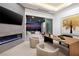 Modern office featuring a fireplace, city views, and sliding glass doors leading to an outdoor lounge area at 665 Overlook Rim Dr, Henderson, NV 89012