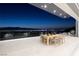 Outdoor patio dining area with a city view at night at 665 Overlook Rim Dr, Henderson, NV 89012