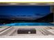 Modern pool and fire feature offering spectacular city views at night from this luxury property at 665 Overlook Rim Dr, Henderson, NV 89012