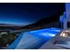 Infinity pool with a mountain and city view at night at 665 Overlook Rim Dr, Henderson, NV 89012