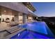 Luxury pool area with waterfall feature, lounge chairs, and modern gym overlooking mountain views at 665 Overlook Rim Dr, Henderson, NV 89012
