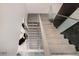 Modern staircase with glass railings and sleek, gray steps leading to the upper level at 665 Overlook Rim Dr, Henderson, NV 89012