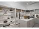Spacious walk-in closet featuring marble accents, custom shelving, and a central island with ample storage at 665 Overlook Rim Dr, Henderson, NV 89012
