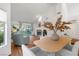 Bright dining room with hardwood floors, chandelier, and view of patio at 6908 Emerald Springs Ln, Las Vegas, NV 89113