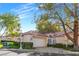 Single-story home with tile roof, attached garage, and landscaped front yard at 6908 Emerald Springs Ln, Las Vegas, NV 89113