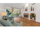 Bright living room with fireplace, hardwood floors, and sliding glass doors at 6908 Emerald Springs Ln, Las Vegas, NV 89113