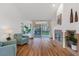 Bright living room with fireplace, hardwood floors, and sliding glass doors at 6908 Emerald Springs Ln, Las Vegas, NV 89113