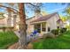 Private patio with two blue chairs and a view of trees at 6908 Emerald Springs Ln, Las Vegas, NV 89113