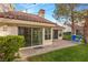 Charming patio with lake view, two blue chairs, and lush green landscaping at 6908 Emerald Springs Ln, Las Vegas, NV 89113