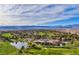 Aerial view of a luxurious golf course community with a clubhouse and scenic landscape at 6908 Emerald Springs Ln, Las Vegas, NV 89113