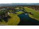 Aerial view of a serene golf course with water features and lush greens at 6908 Emerald Springs Ln, Las Vegas, NV 89113