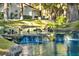 Ducks swim near a charming waterfall and pond at 6908 Emerald Springs Ln, Las Vegas, NV 89113