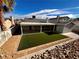 Artificial turf backyard with covered patio and mountain view at 730 Brick Dr, Henderson, NV 89002