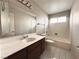 Simple bathroom with single vanity and a bathtub at 730 Brick Dr, Henderson, NV 89002