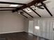 Living room featuring a vaulted ceiling with exposed beams and wood floors at 730 Brick Dr, Henderson, NV 89002