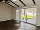 Living room with dark hardwood floors and sliding glass doors at 730 Brick Dr, Henderson, NV 89002