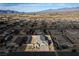 Aerial view of a single-story house and surrounding neighborhood in a desert setting at 74 Wildcat Ave, Pahrump, NV 89060