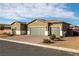 Single-story house with three-car garage and desert landscaping at 74 Wildcat Ave, Pahrump, NV 89060