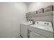 Laundry room with washer, dryer, and shelving at 74 Wildcat Ave, Pahrump, NV 89060