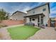 Artificial turf backyard with covered patio and seating at 7960 Brookside Falls Ct, Las Vegas, NV 89166