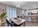 Bright dining area with wood table and modern chairs at 7960 Brookside Falls Ct, Las Vegas, NV 89166