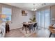 Dining area with wooden table, gray chairs, and hardwood floors at 7960 Brookside Falls Ct, Las Vegas, NV 89166