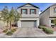 Two-story house with gray siding, shutters, and a paved driveway at 7960 Brookside Falls Ct, Las Vegas, NV 89166