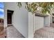 Front door and walkway leading to a gray garage door at 7960 Brookside Falls Ct, Las Vegas, NV 89166