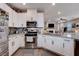 Modern kitchen with white cabinets and stainless steel appliances at 7960 Brookside Falls Ct, Las Vegas, NV 89166