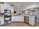 Modern kitchen with white cabinets and stainless steel appliances at 7960 Brookside Falls Ct, Las Vegas, NV 89166