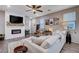 Living room with sectional sofa, electric fireplace, and wood-look floors at 7960 Brookside Falls Ct, Las Vegas, NV 89166