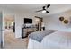 Main bedroom with dresser, sliding barn door to closet, and TV at 7960 Brookside Falls Ct, Las Vegas, NV 89166