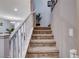 Modern carpeted staircase with white railing at 7960 Brookside Falls Ct, Las Vegas, NV 89166