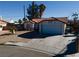 Single-story house with tile roof, attached garage, and a driveway at 8072 Hackberry Dr, Las Vegas, NV 89123