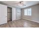 Bedroom with wood-look floors, window coverings, and closet at 8130 Skye Sweep St, Las Vegas, NV 89166