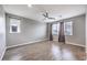 Bright bedroom with ceiling fan, window coverings, and wood-look floors at 8130 Skye Sweep St, Las Vegas, NV 89166