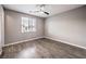 Bright bedroom with wood-look floors and ceiling fan at 8130 Skye Sweep St, Las Vegas, NV 89166