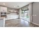 Kitchen with white cabinets, island, and sliding glass door to backyard at 8130 Skye Sweep St, Las Vegas, NV 89166