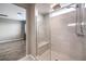 Walk-in shower with glass enclosure, seat, and bright window at 8130 Skye Sweep St, Las Vegas, NV 89166