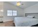 Spacious bedroom with carpeted floor, large bed, and ceiling fan at 8424 Oyster Dr, Las Vegas, NV 89128