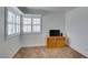 Simple bedroom with wood dresser and neutral carpeting at 8424 Oyster Dr, Las Vegas, NV 89128