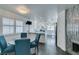 Modern dining area with a round table and four blue chairs, open to kitchen at 8424 Oyster Dr, Las Vegas, NV 89128