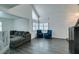 Living room with gray sectional sofa and large windows at 8424 Oyster Dr, Las Vegas, NV 89128